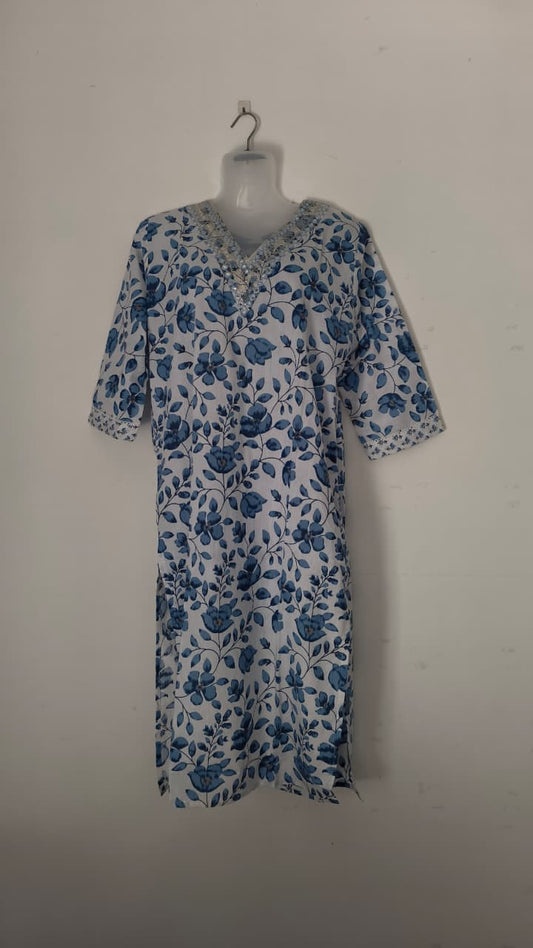 White dress with blue floral print.